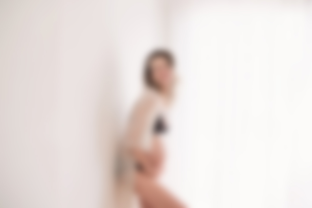 Pregnant woman in flowing dress during a maternity portrait session
