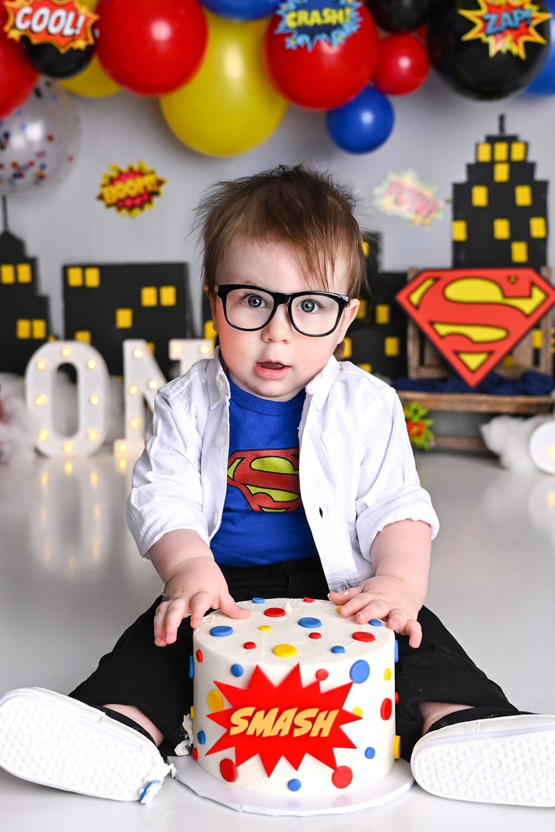 One year old baby celebrating a cake smash session