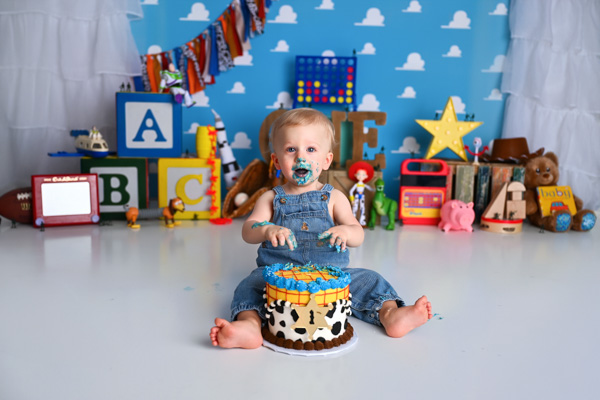 Baby covered in cake during a joyful session