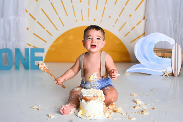 One year old baby celebrating with a cake