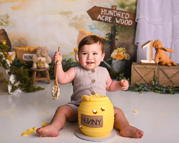 Toddler joyfully celebrating with cake