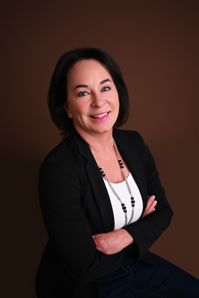 Corporate headshot against a neutral background