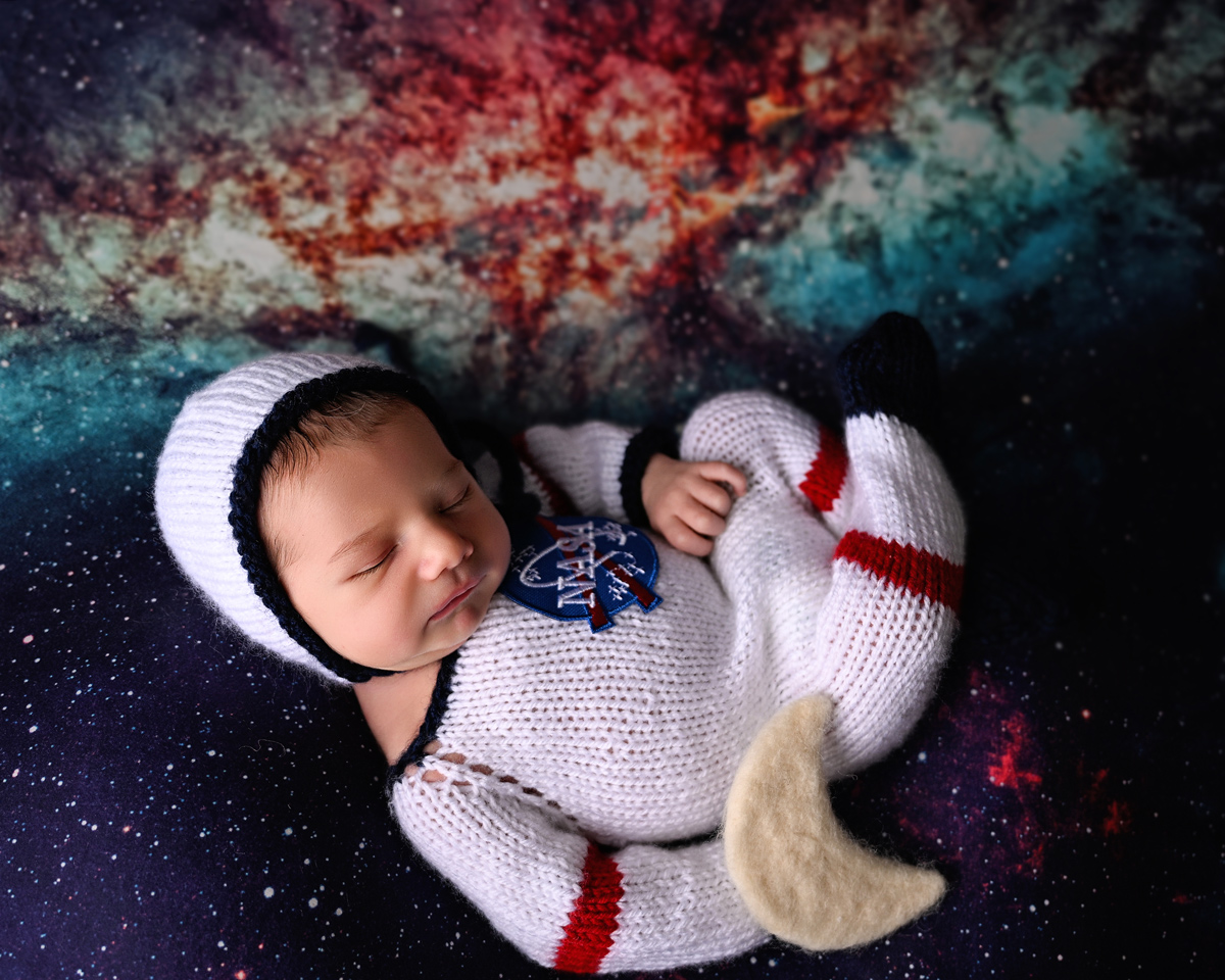 Olivia Grace holding a newborn baby during a photography session in Phoenix