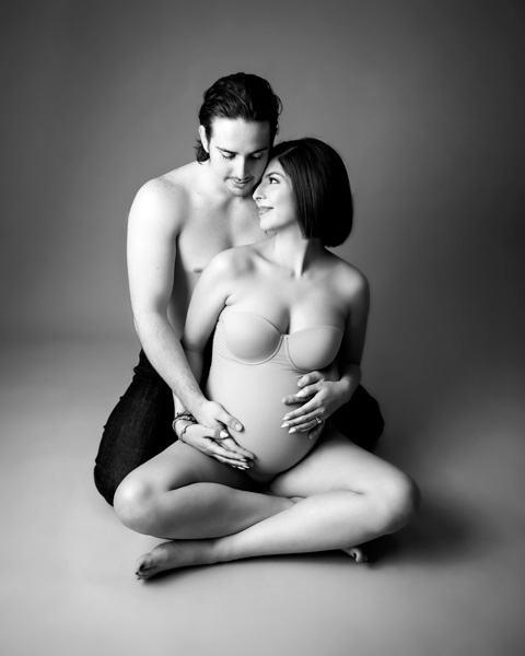 Pregnant woman cradling her belly