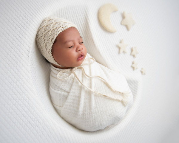Newborn baby held close by parents