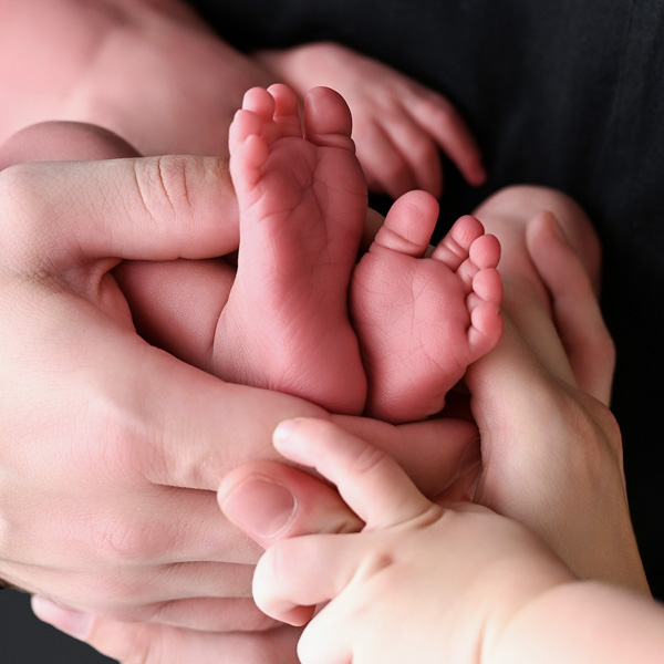 Newborn baby with parents and siblings