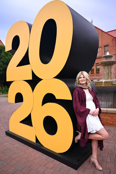 Senior photographed in graduation attire